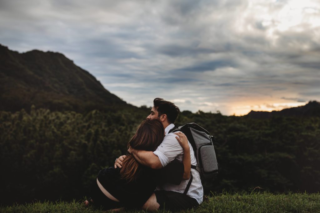couple cuddling after hike oahu hawaii