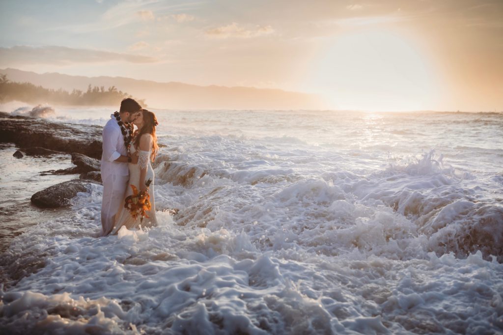 Bride & Groom kissing in ocean. hawaiian oahu elopement beach wedding